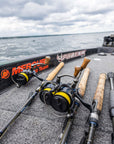 Five fishing poles are lying on a boat.