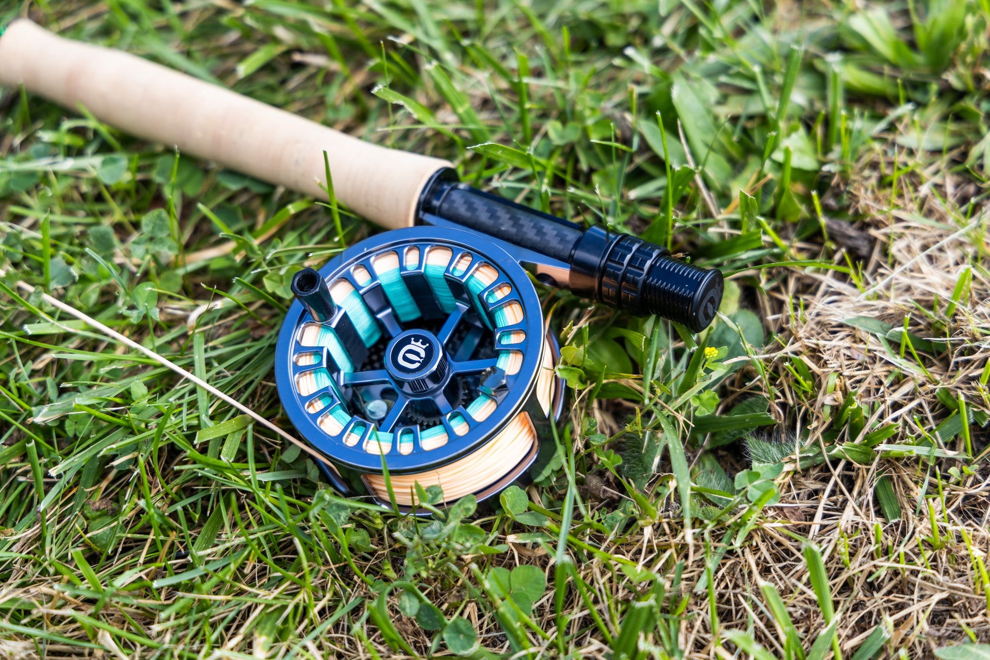 Retro X Click fishing reel on grass