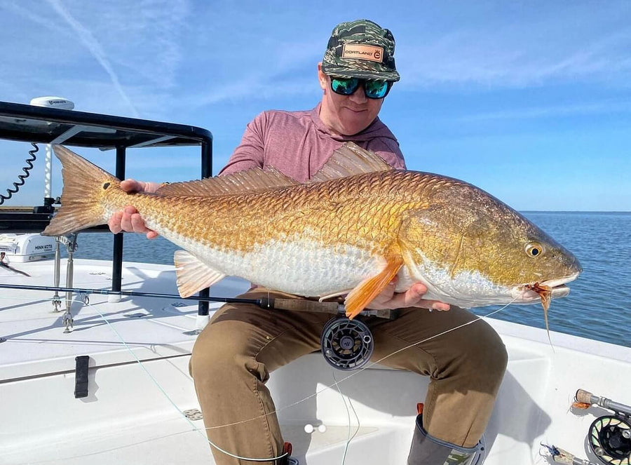 Chris holding up a redfish