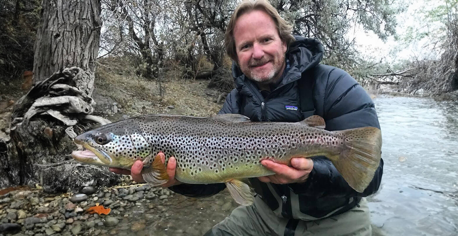 Kelly Galloup holding up a fish 