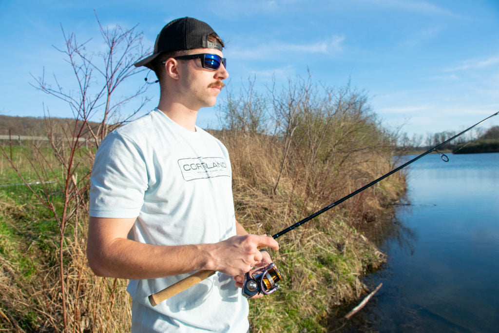 A fisherman is holding onto a fishing pole 