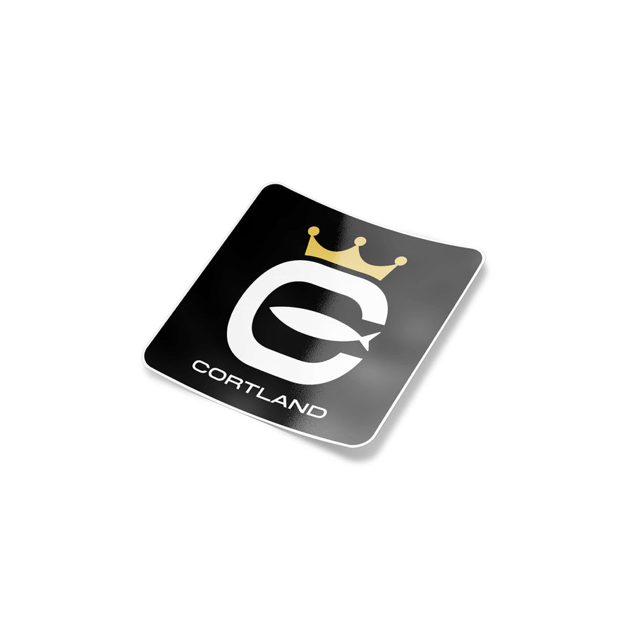 Cortland Logo Slap Sticker. The Cortland logo is in white font, with a black background. The crown is a gold color. 