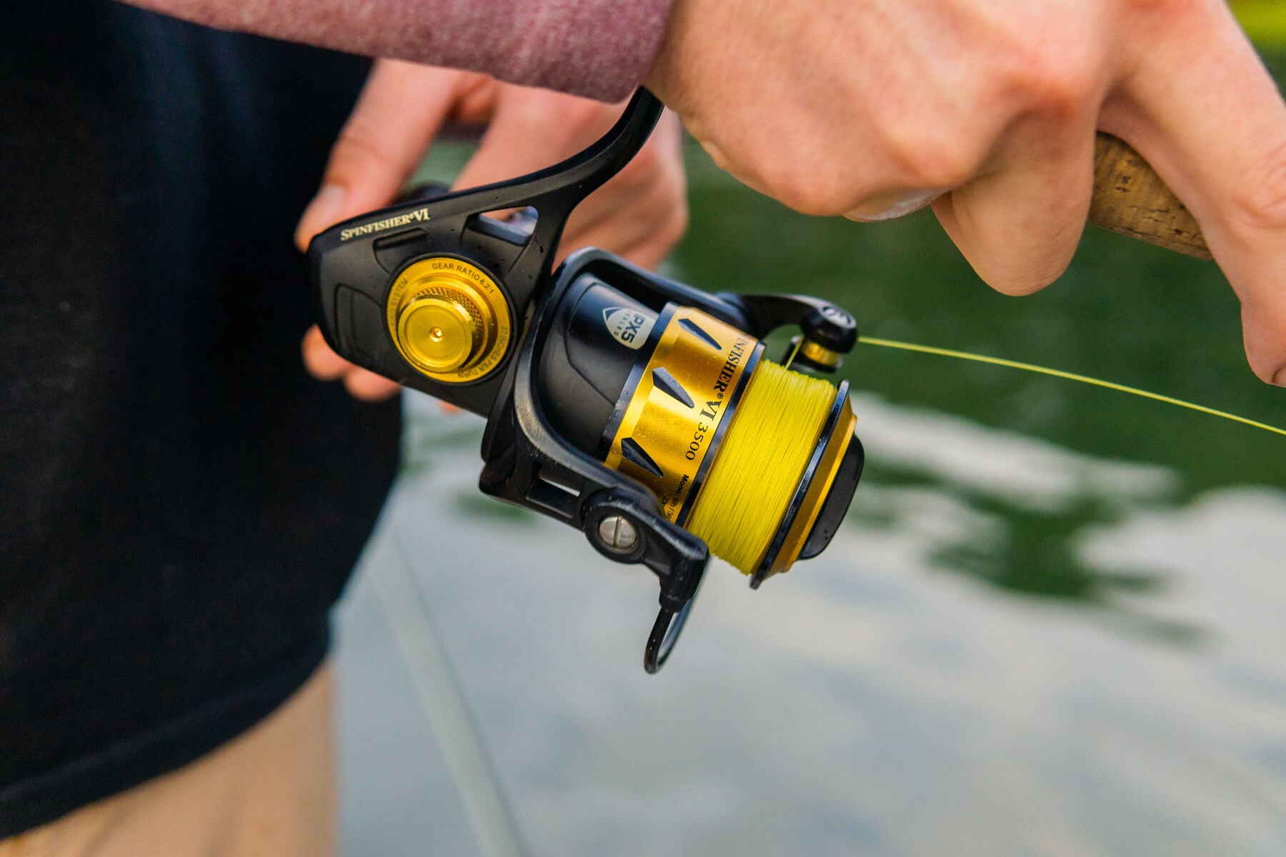Closeup shot of a fishing reel that is lined with Cortland Master Braid - Yellow. 